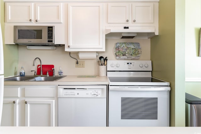 609 Hillside Dr S Unit C-10, North Myrtle Beach, SC 29582 - kitchen featuring white appliances, under cabinet range hood, white cabinetry, and light countertops