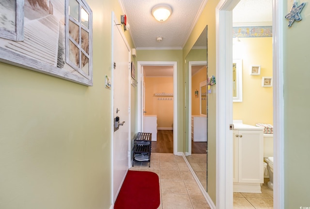 609 Hillside Dr S Unit C-10, North Myrtle Beach, SC 29582 - hallway with a textured ceiling, light tile patterned flooring, and crown molding