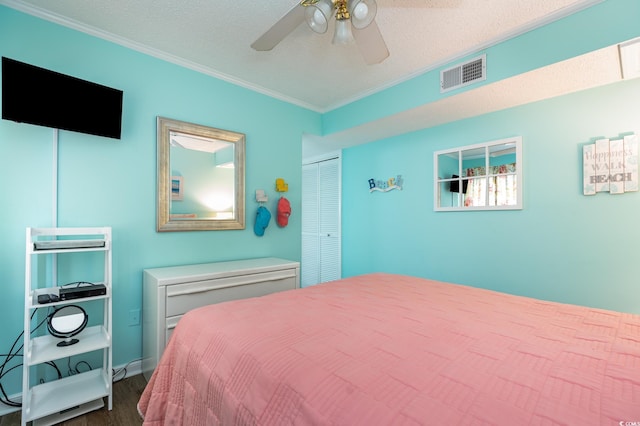 609 Hillside Dr S Unit C-10, North Myrtle Beach, SC 29582 - bedroom with dark wood-style floors, ornamental molding, a closet, a ceiling fan, and a textured ceiling
