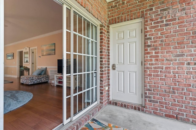 view of exterior entry with brick siding