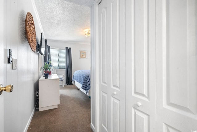 5601 N Ocean Blvd Unit C-106, Myrtle Beach, SC 29577 - bedroom with a textured ceiling, baseboards, and dark colored carpet