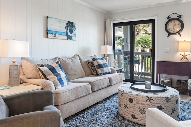 living room with ornamental molding and wood finished floors