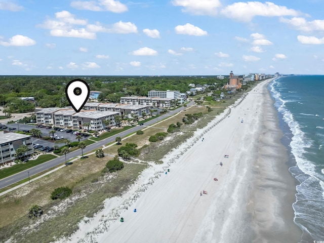aerial view with a water view and a beach view