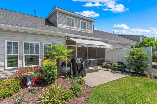 232 Je Edward Dr Unit 21, Myrtle Beach, SC 29588 - rear view of property with fence, a patio, a lawn, and roof with shingles