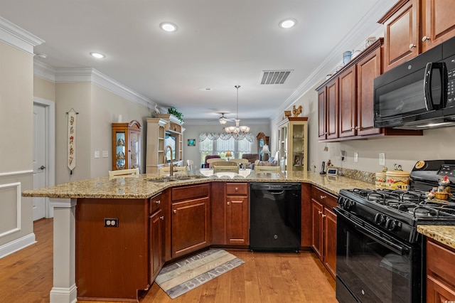 232 Je Edward Dr Unit 21, Myrtle Beach, SC 29588 - kitchen with an inviting chandelier, a sink, light wood-style floors, visible vents, and black appliances