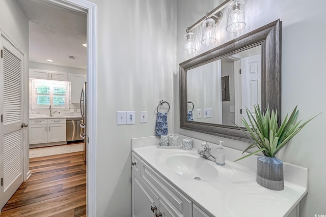 bathroom featuring wood finished floors and vanity