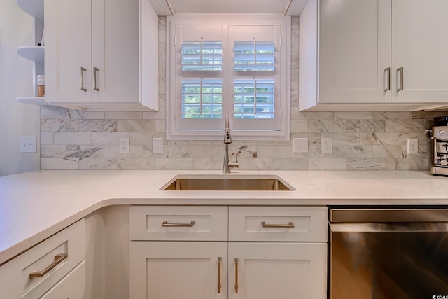 kitchen featuring light countertops, white cabinetry, a sink, and dishwasher