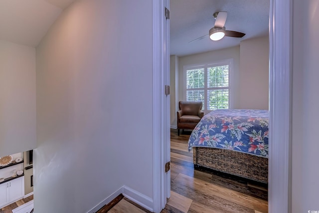 bedroom featuring baseboards, ceiling fan, and wood finished floors