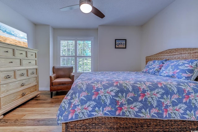 bedroom with baseboards, ceiling fan, and light wood finished floors