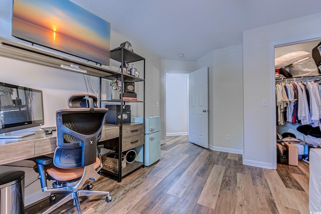 office space featuring baseboards and wood finished floors