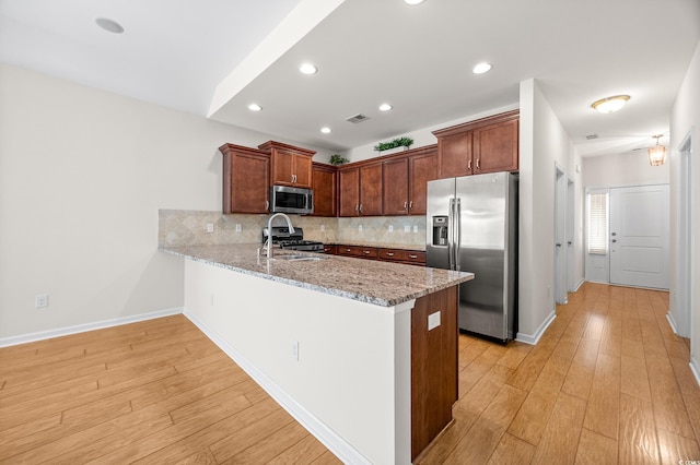 962 Witherbee Way, Little River, SC 29566 - kitchen with appliances with stainless steel finishes, a sink, a peninsula, decorative backsplash, and visible vents
