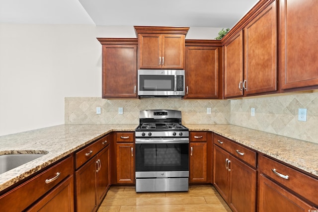 962 Witherbee Way, Little River, SC 29566 - kitchen with light wood-style floors, decorative backsplash, light stone countertops, and stainless steel appliances