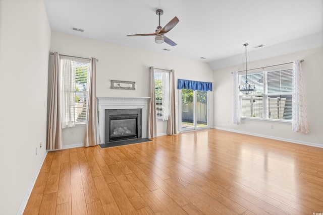 962 Witherbee Way, Little River, SC 29566 - unfurnished living room featuring a healthy amount of sunlight, baseboards, ceiling fan with notable chandelier, and visible vents