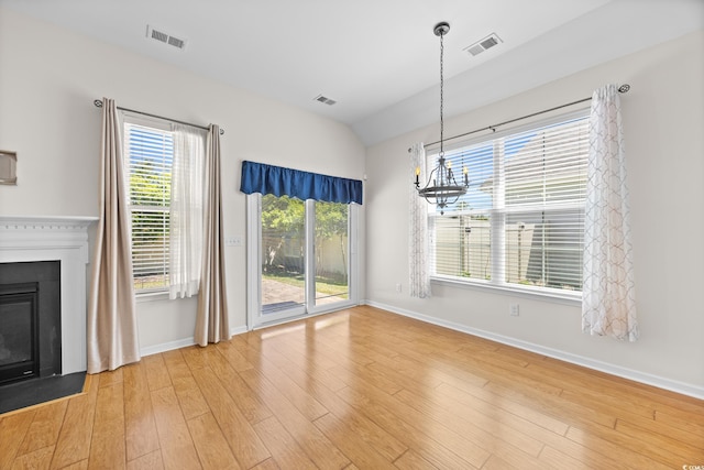 962 Witherbee Way, Little River, SC 29566 - unfurnished dining area with visible vents, wood finished floors, baseboards, a chandelier, and a glass covered fireplace