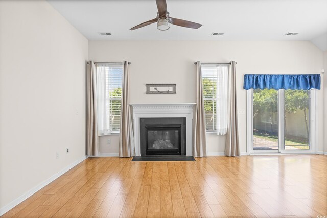 962 Witherbee Way, Little River, SC 29566 - unfurnished living room with a fireplace with flush hearth, a ceiling fan, wood finished floors, and visible vents