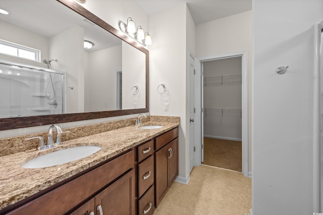 962 Witherbee Way, Little River, SC 29566 - bathroom featuring double vanity, a walk in closet, a sink, and a stall shower