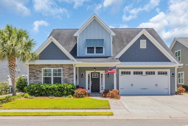 1136 Doubloon Dr, North Myrtle Beach, SC 29582 - craftsman-style house featuring an attached garage, a front lawn, stone siding, board and batten siding, and concrete driveway