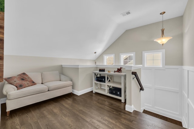 1136 Doubloon Dr, North Myrtle Beach, SC 29582 - living area featuring dark wood-style flooring, vaulted ceiling, a healthy amount of sunlight, and visible vents