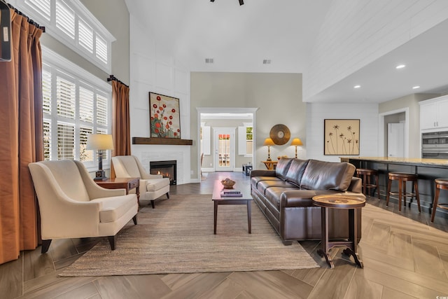 1136 Doubloon Dr, North Myrtle Beach, SC 29582 - living area with plenty of natural light, a high ceiling, visible vents, and a large fireplace