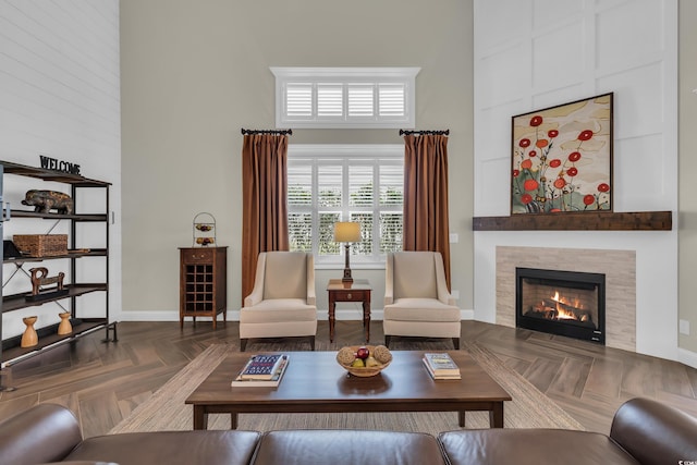 1136 Doubloon Dr, North Myrtle Beach, SC 29582 - living area featuring baseboards, a tile fireplace, and a towering ceiling