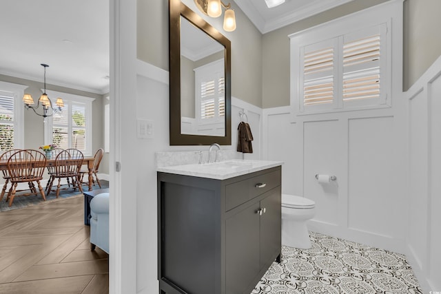 1136 Doubloon Dr, North Myrtle Beach, SC 29582 - bathroom featuring toilet, a notable chandelier, ornamental molding, and a wainscoted wall