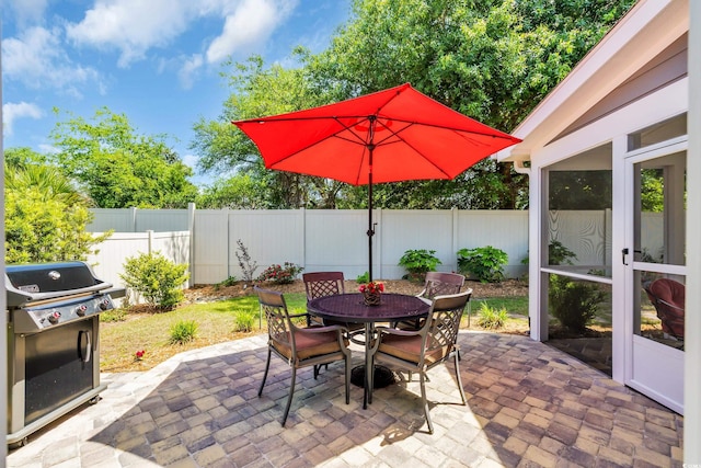 1136 Doubloon Dr, North Myrtle Beach, SC 29582 - view of patio / terrace with grilling area, outdoor dining area, and a fenced backyard