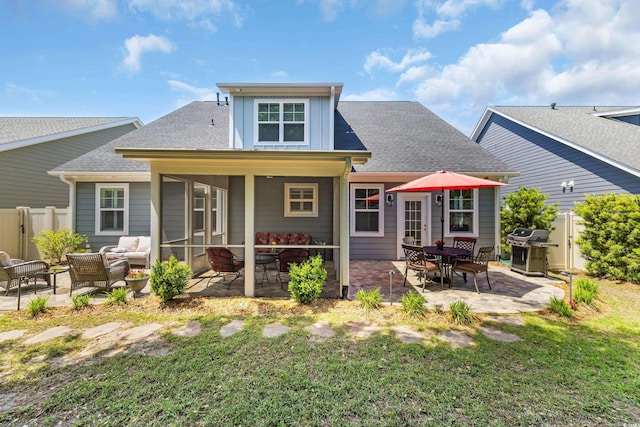 1136 Doubloon Dr, North Myrtle Beach, SC 29582 - rear view of property with a patio, a shingled roof, fence, and a yard