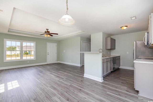 469 Overcrest St, Myrtle Beach, SC 29579 - kitchen featuring a raised ceiling, appliances with stainless steel finishes, light countertops, ceiling fan, and wood finished floors