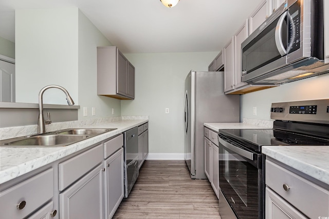 469 Overcrest St, Myrtle Beach, SC 29579 - kitchen featuring appliances with stainless steel finishes, light wood finished floors, light countertops, and gray cabinetry