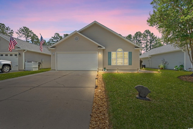ranch-style house with a garage, a yard, and concrete driveway