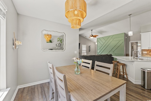 dining space with a ceiling fan, baseboards, dark wood-style floors, and lofted ceiling