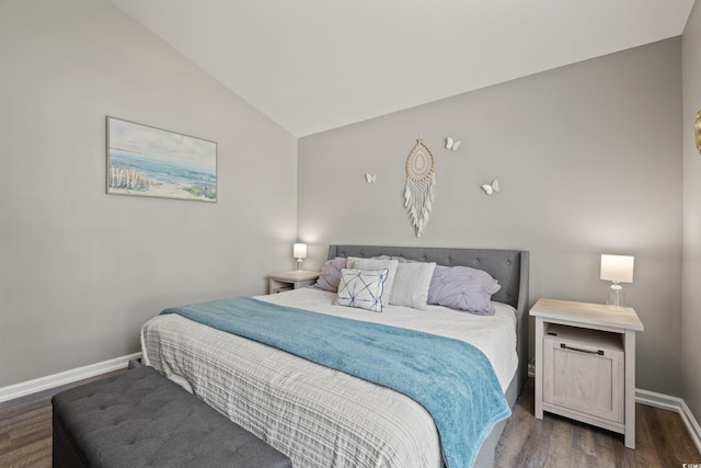 bedroom with baseboards, wood finished floors, and lofted ceiling