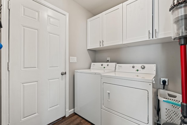 washroom featuring baseboards, dark wood-type flooring, cabinet space, and washer and dryer