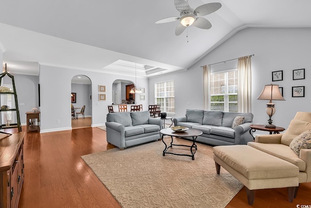 living room featuring arched walkways, ceiling fan with notable chandelier, hardwood / wood-style floors, and lofted ceiling