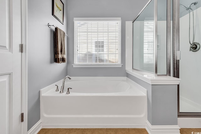 full bath featuring a shower stall and a garden tub