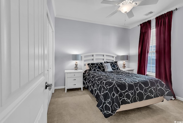 bedroom with carpet floors, baseboards, visible vents, and ornamental molding
