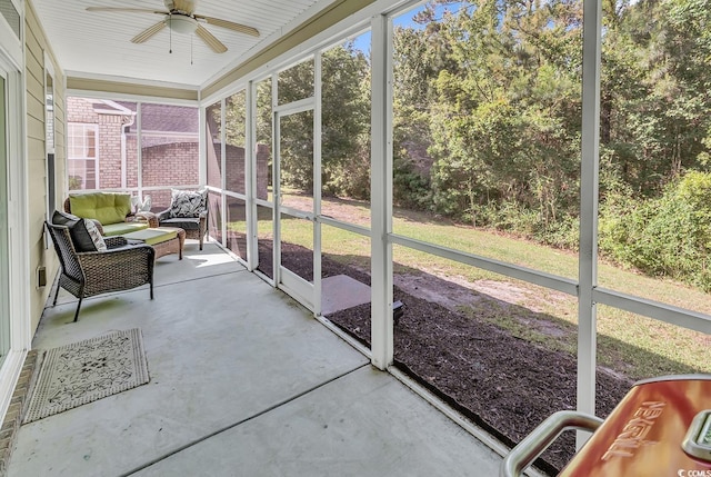 sunroom featuring ceiling fan