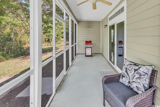 sunroom / solarium featuring ceiling fan