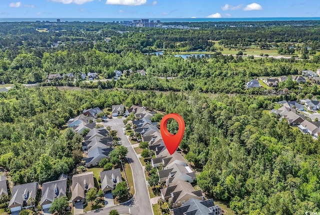 birds eye view of property featuring a residential view, a water view, and a forest view
