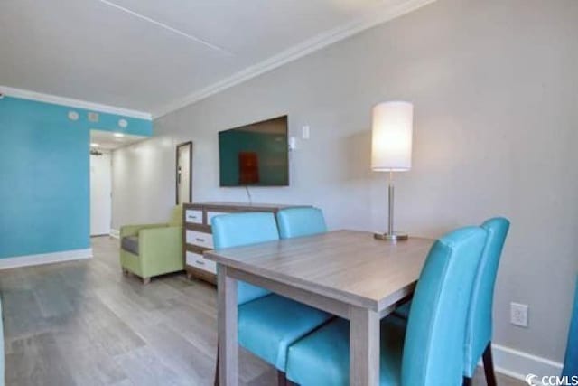 7200 N Ocean Blvd Unit 436, Myrtle Beach, SC 29572 - dining area with crown molding, baseboards, and wood finished floors