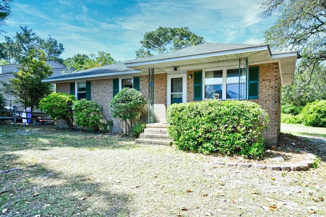 view of front facade featuring brick siding and covered porch