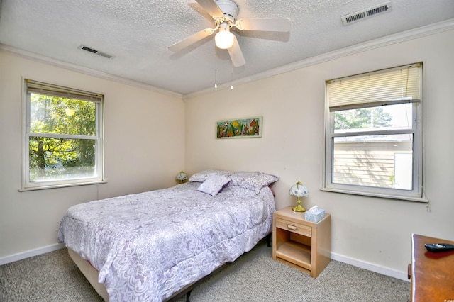 bedroom featuring carpet flooring, multiple windows, crown molding, baseboards, and a textured ceiling