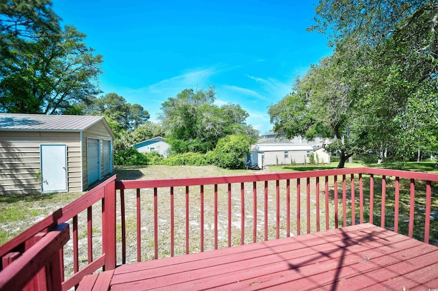 deck featuring an outbuilding and a yard