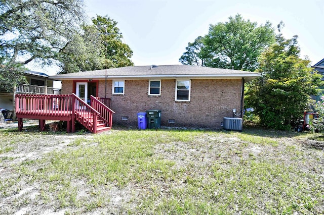 rear view of house with crawl space, a wooden deck, cooling unit, and brick siding