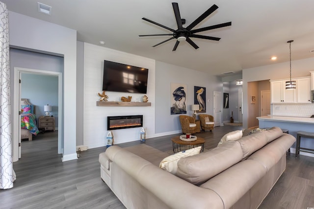 428 Calhoun Falls Dr, Myrtle Beach, SC 29579 - living area featuring a ceiling fan, baseboards, dark wood-style flooring, a glass covered fireplace, and recessed lighting