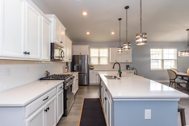 428 Calhoun Falls Dr, Myrtle Beach, SC 29579 - kitchen featuring appliances with stainless steel finishes, a sink, a center island with sink, decorative backsplash, and white cabinets