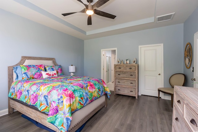 428 Calhoun Falls Dr, Myrtle Beach, SC 29579 - bedroom featuring dark wood-style flooring, a tray ceiling, and a ceiling fan