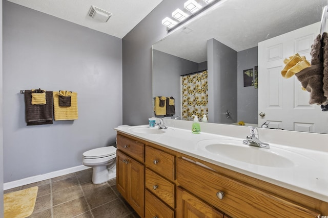 bathroom featuring toilet, baseboards, double vanity, tile patterned floors, and a shower with curtain