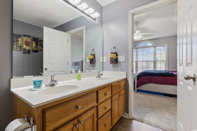 ensuite bathroom featuring double vanity and ceiling fan