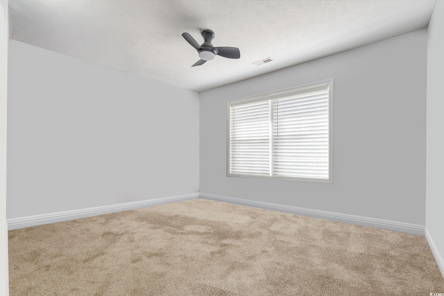 unfurnished room featuring carpet, baseboards, and a ceiling fan